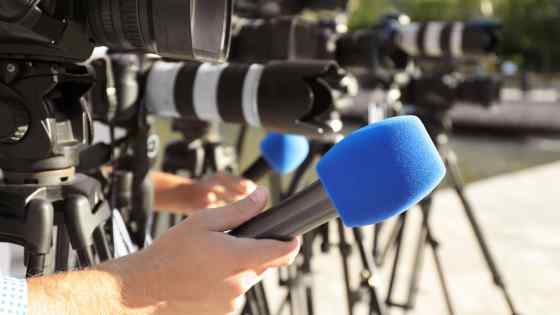 News reporter microphone and cameras